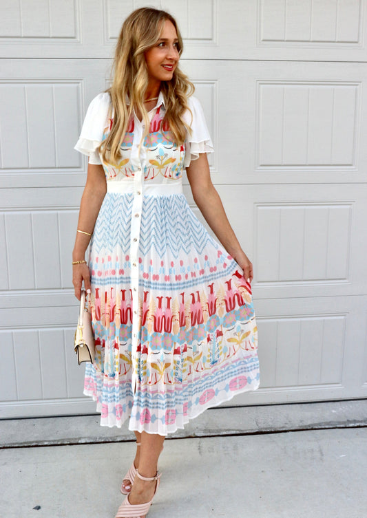Feminine styling with the Rio multi colors pink red yellow blue buttons puff  Dress!  - True to size  - Light and Airy  - Material: 55% polyester 45% cotton