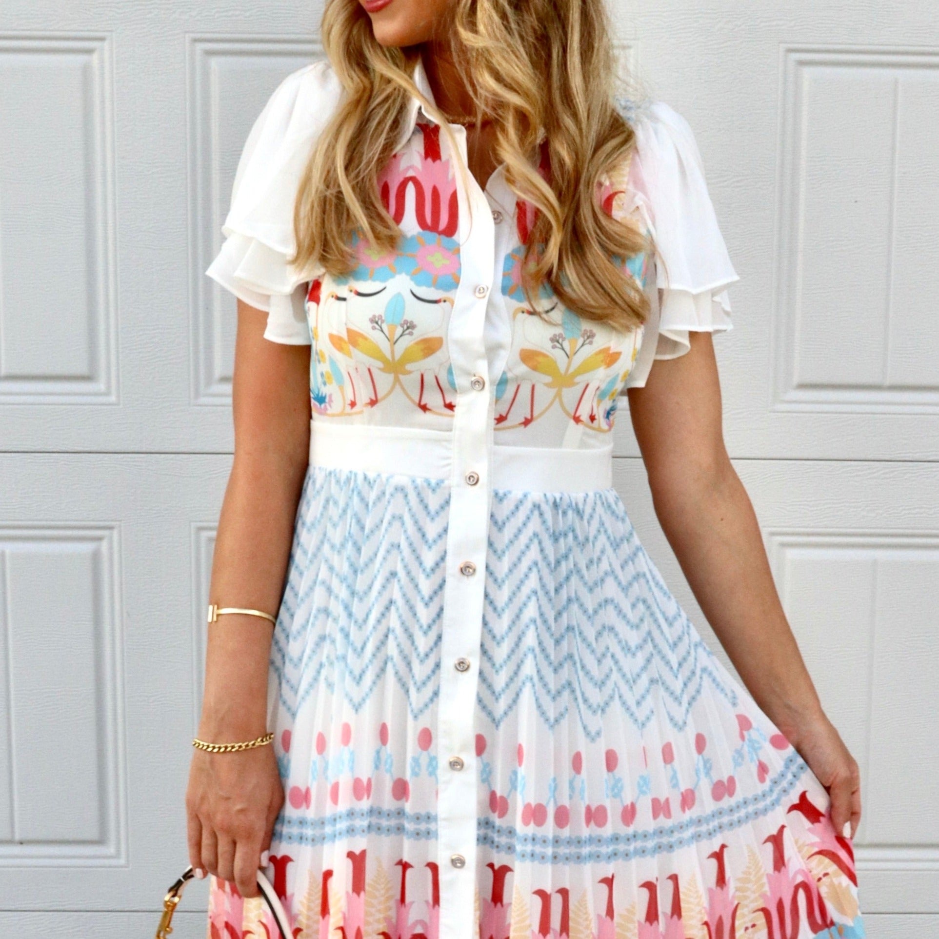 Feminine styling with the Rio multi colors pink red yellow blue buttons puff  Dress!  - True to size  - Light and Airy  - Material: 55% polyester 45% cotton
